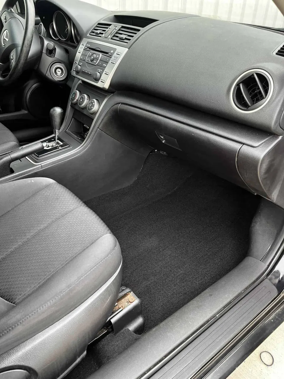 After: the same footwell vacuumed and cleaned